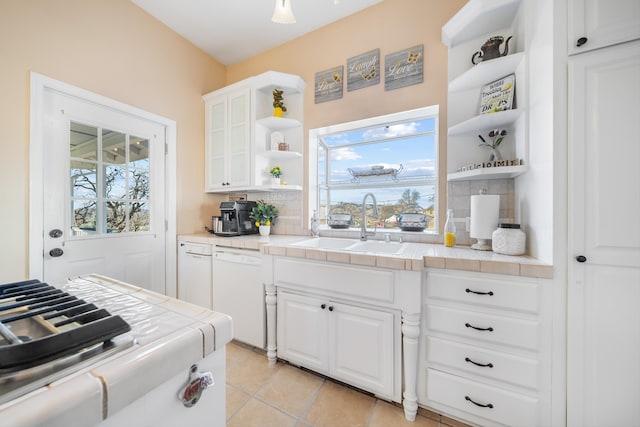 kitchen with white cabinetry, sink, tile countertops, and white dishwasher