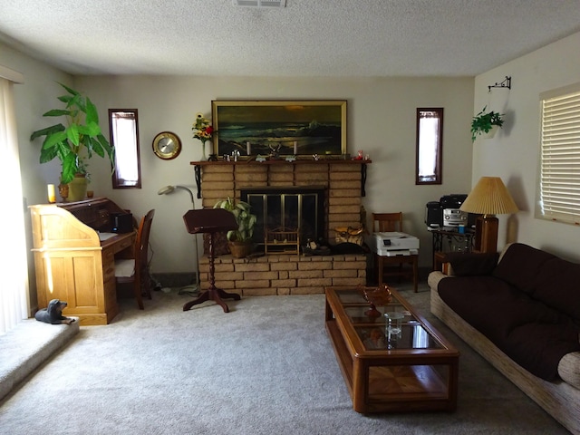 living room with a textured ceiling, carpet floors, a fireplace, and visible vents