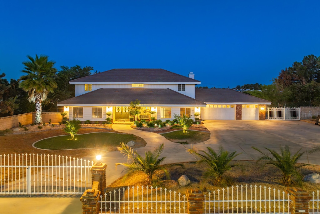 view of front of property featuring a garage and a yard