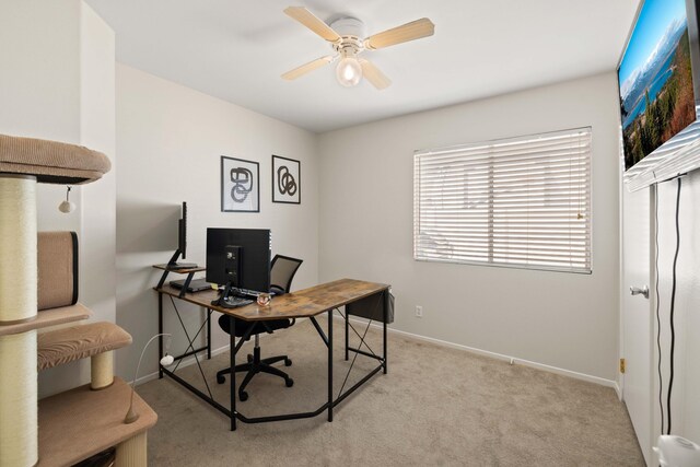 office with baseboards, a ceiling fan, and light carpet