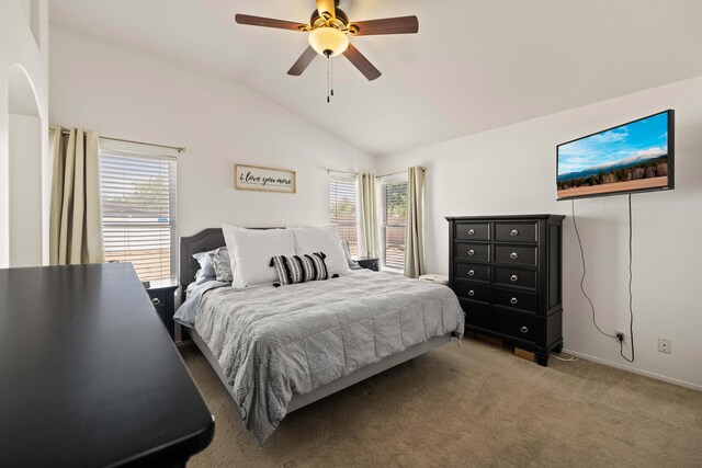 carpeted bedroom featuring baseboards, a ceiling fan, lofted ceiling, and multiple windows