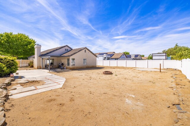 view of yard featuring a patio, a fire pit, and a fenced backyard