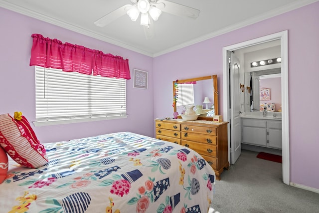 carpeted bedroom with ensuite bath, ceiling fan, and ornamental molding