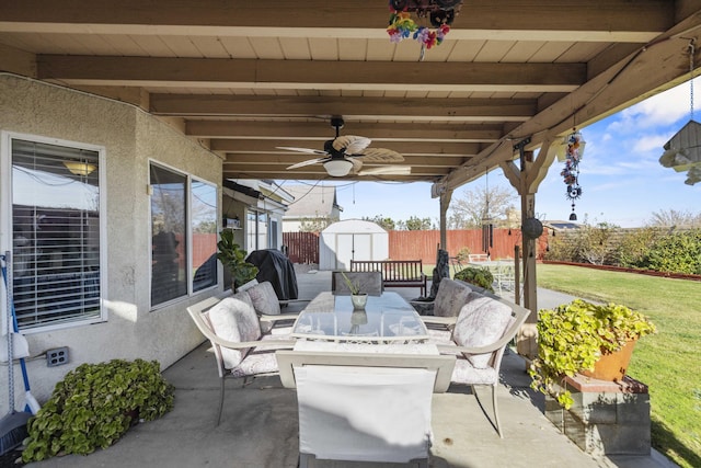 view of patio featuring ceiling fan and a storage unit