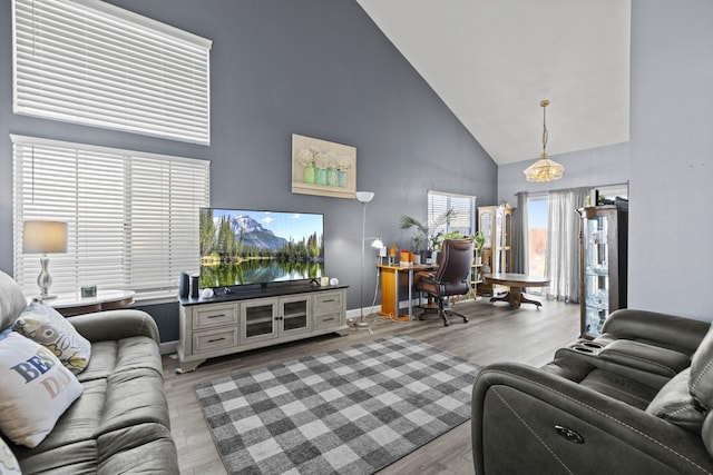 living room featuring light hardwood / wood-style floors and high vaulted ceiling