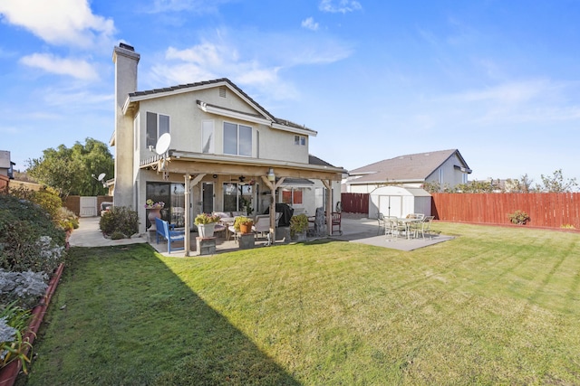 rear view of house featuring a patio area, a yard, an outdoor hangout area, and a shed