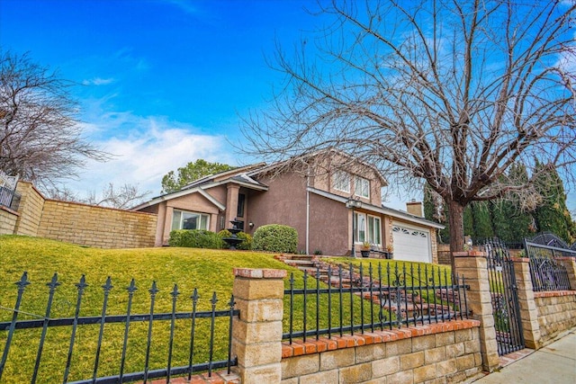 view of front of house featuring a garage and a front yard