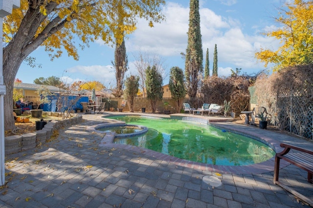 view of pool with an in ground hot tub and a patio