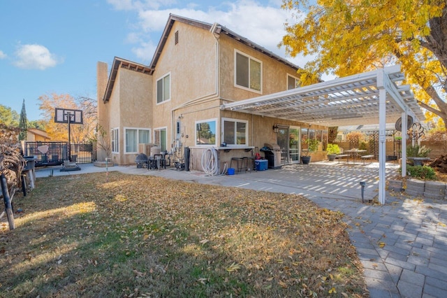 rear view of property featuring an outdoor bar, a pergola, and a patio