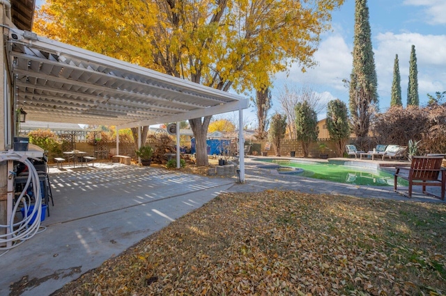 view of yard featuring a fenced in pool and a patio