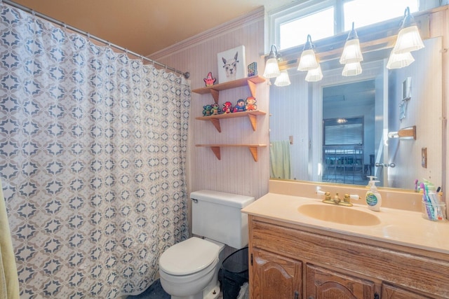 bathroom with a shower with curtain, vanity, toilet, and crown molding