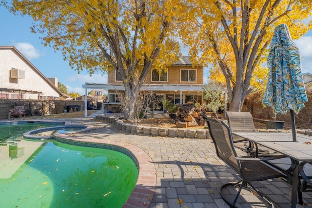 view of pool featuring an in ground hot tub and a patio