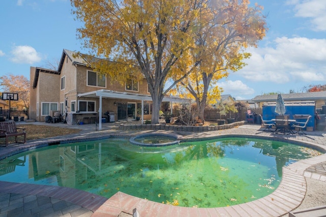 view of pool featuring an in ground hot tub and a patio