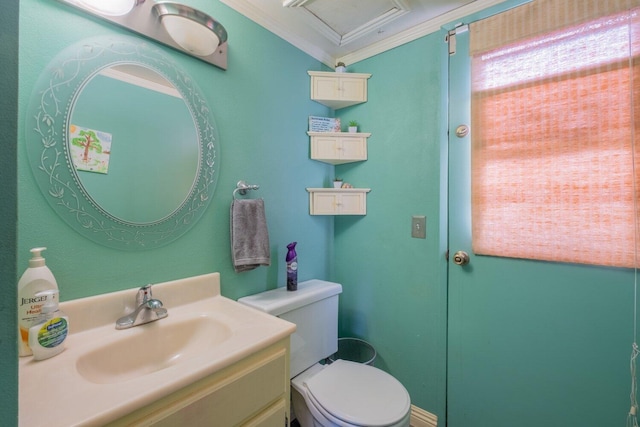 bathroom featuring toilet, vanity, and ornamental molding