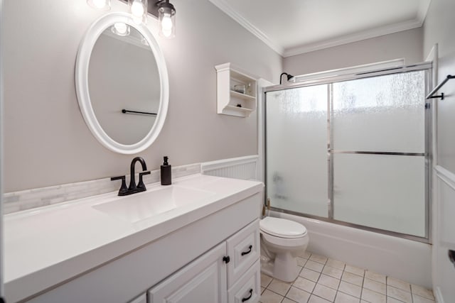 full bathroom with vanity, shower / bath combination with glass door, crown molding, tile patterned flooring, and toilet