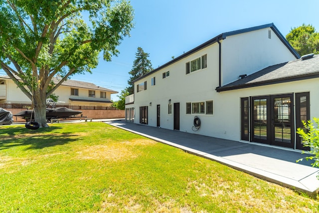 back of property featuring french doors, a yard, and a patio