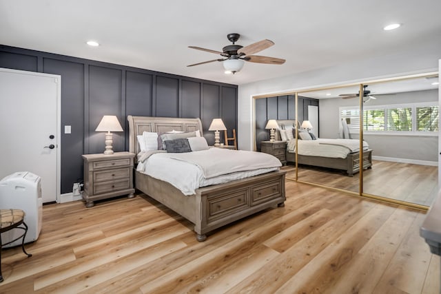 bedroom with ceiling fan, a closet, and light hardwood / wood-style flooring