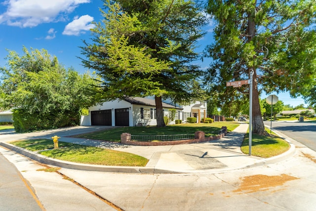 view of front of home with a garage and a front lawn