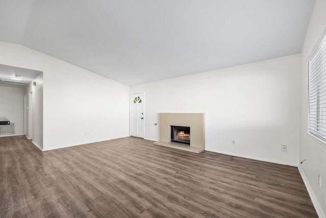 unfurnished living room with dark hardwood / wood-style flooring and vaulted ceiling