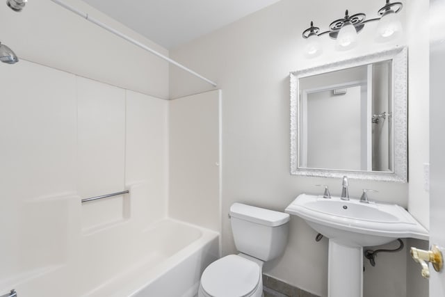 bathroom with bathing tub / shower combination and toilet