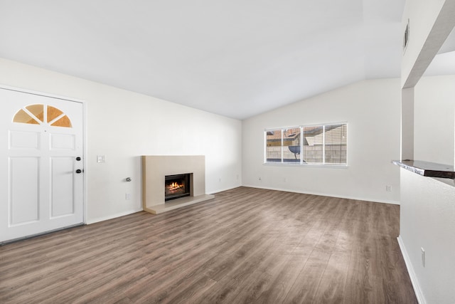 unfurnished living room with dark wood-type flooring and lofted ceiling