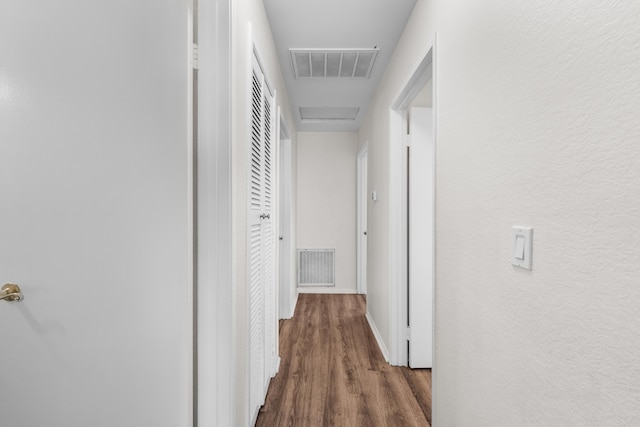 hallway featuring dark hardwood / wood-style flooring