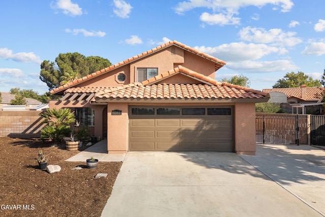 2512 Mildwood Ct, Lancaster, CA 93536 - mediterranean / spanish house featuring driveway, a garage, stucco siding, and a tiled roof