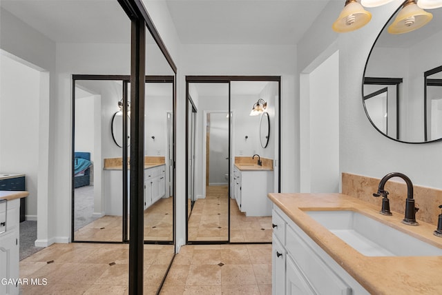 2512 Mildwood Ct, Lancaster, CA 93536 - full bath featuring two vanities and baseboards