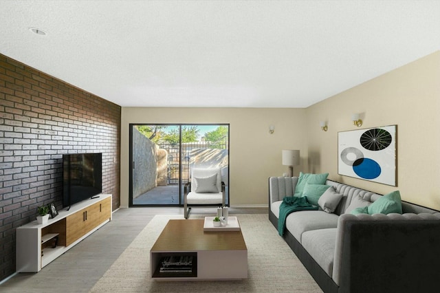 living room featuring a fireplace, hardwood / wood-style floors, and a textured ceiling