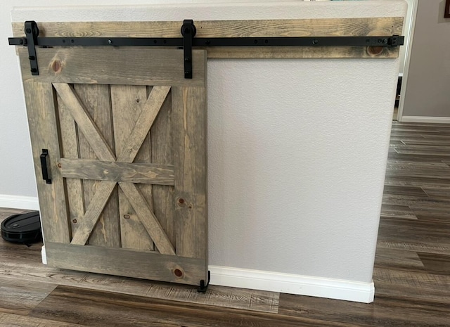 room details featuring hardwood / wood-style floors and a barn door