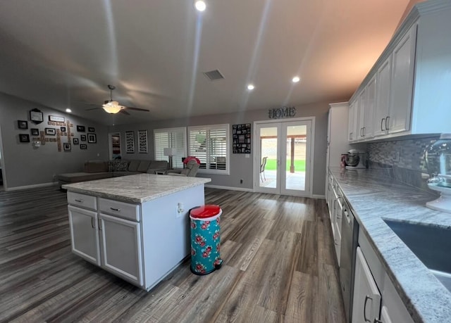 kitchen with white cabinetry, ceiling fan, dark wood-type flooring, and light stone counters