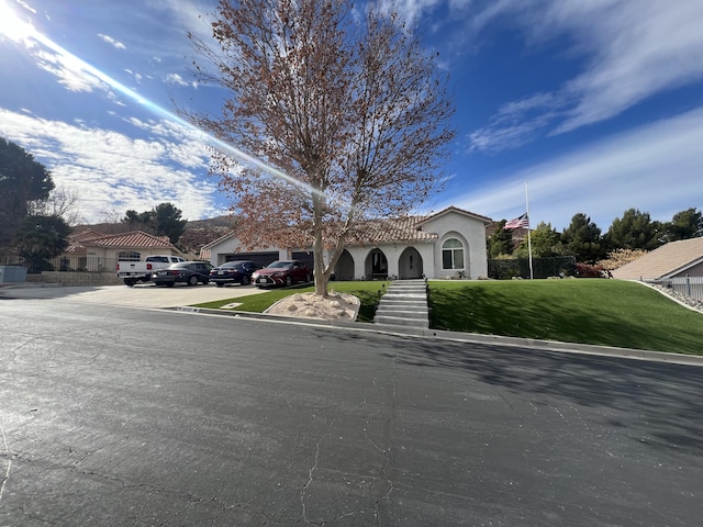 mediterranean / spanish home with a front lawn