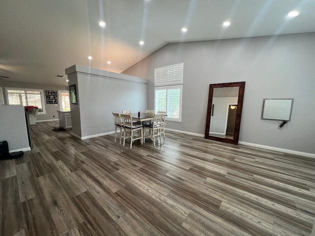 dining space featuring lofted ceiling and dark hardwood / wood-style floors