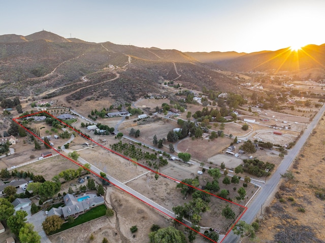 aerial view at dusk featuring a mountain view