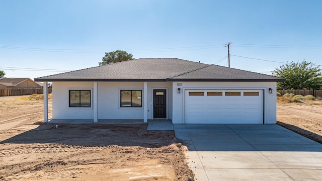 single story home with driveway, a shingled roof, an attached garage, fence, and stucco siding