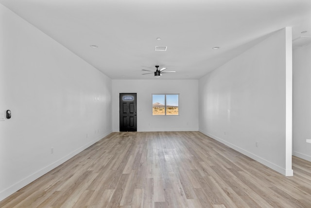 unfurnished living room with light wood-style flooring, visible vents, ceiling fan, and baseboards