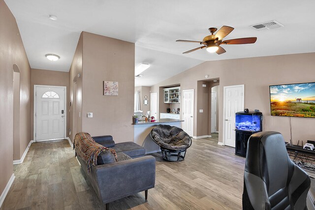 dining area featuring wood-type flooring, lofted ceiling, and a notable chandelier