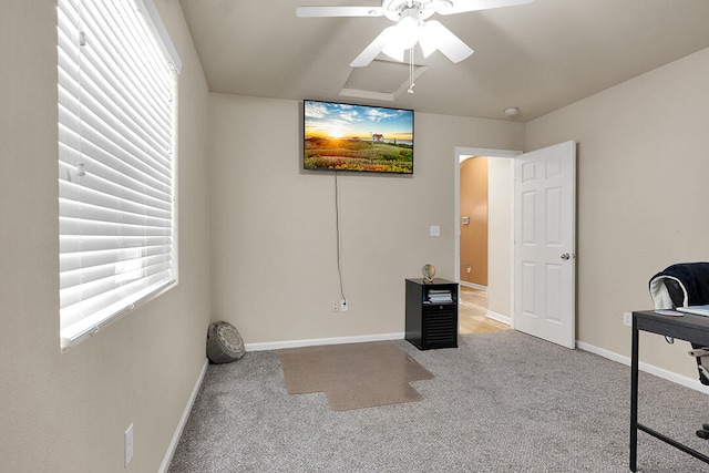 unfurnished office featuring carpet flooring and ceiling fan