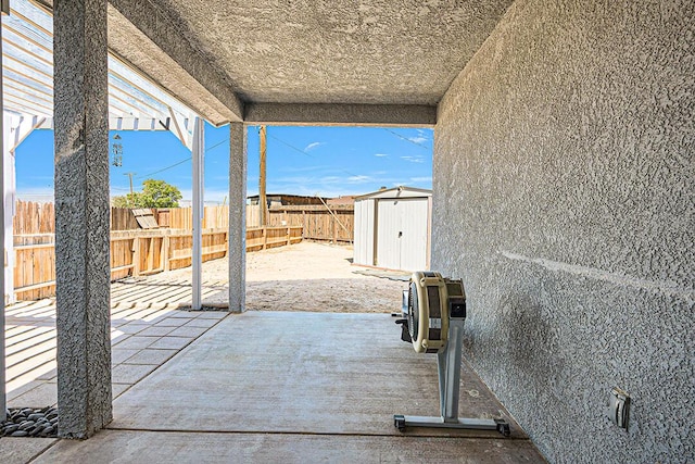 view of patio / terrace featuring a storage shed