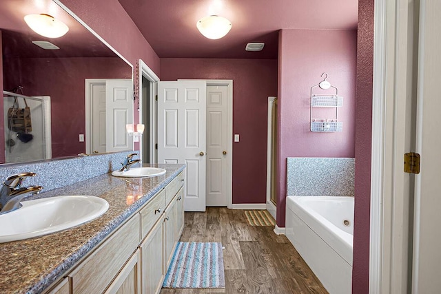 bathroom featuring wood-type flooring, vanity, and independent shower and bath