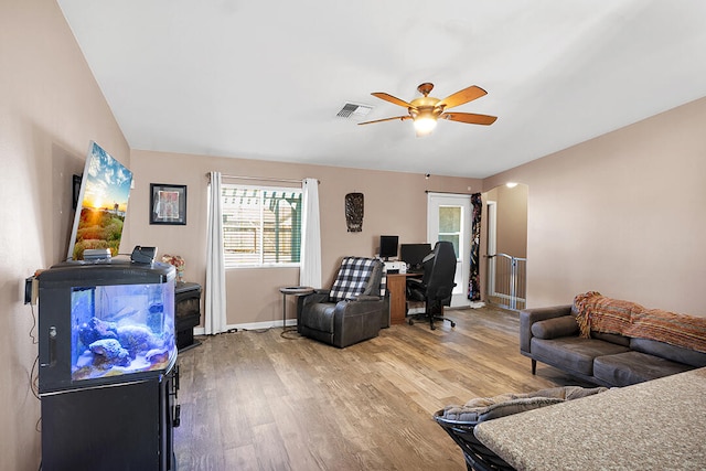 living room with hardwood / wood-style floors and ceiling fan