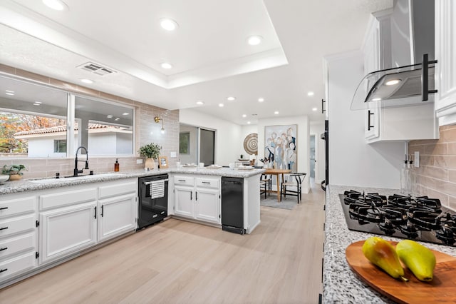 41901 Cll Clarita, Lancaster, CA 93536 - kitchen featuring wall chimney range hood, black appliances, a peninsula, white cabinetry, and tasteful backsplash
