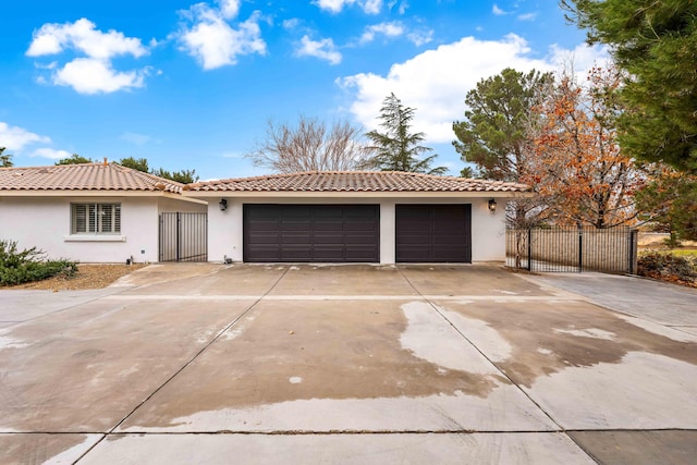 41901 Cll Clarita, Lancaster, CA 93536 - view of front of home featuring concrete driveway, stucco siding, an attached garage, and a tiled roof