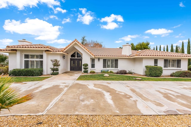 41901 Cll Clarita, Lancaster, CA 93536 - view of front facade featuring a chimney, stucco siding, a front yard, and a tiled roof