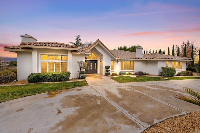 41901 Cll Clarita, Lancaster, CA 93536 - view of front facade featuring a chimney, stucco siding, a tile roof, and a lawn