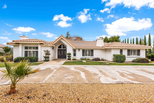 41901 Cll Clarita, Lancaster, CA 93536 - view of front facade featuring a chimney, stucco siding, a tile roof, and french doors