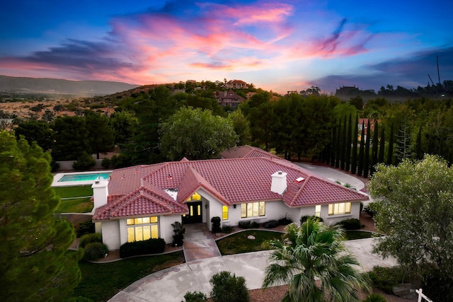 41901 Cll Clarita, Lancaster, CA 93536 - mediterranean / spanish-style house featuring a chimney, a tile roof, stucco siding, and french doors