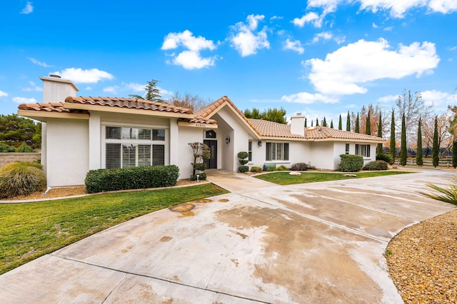 41901 Cll Clarita, Lancaster, CA 93536 - mediterranean / spanish house featuring a chimney, stucco siding, a front lawn, and a tile roof