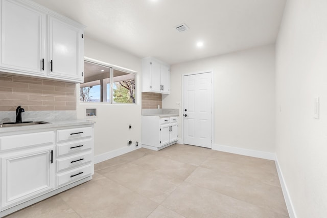 41901 Cll Clarita, Lancaster, CA 93536 - washroom with hookup for a washing machine, hookup for an electric dryer, cabinet space, and light tile patterned flooring