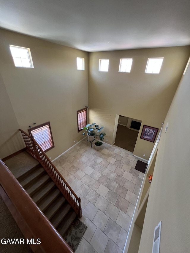 2812 Crocus Pl, Palmdale, CA 93551 - entrance foyer with a high ceiling, healthy amount of natural light, and stairs